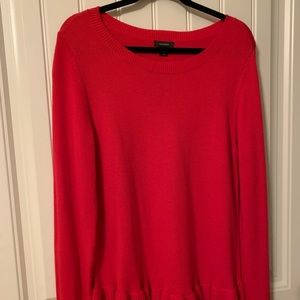 Red pullover sweater with ruffle trim on bottom